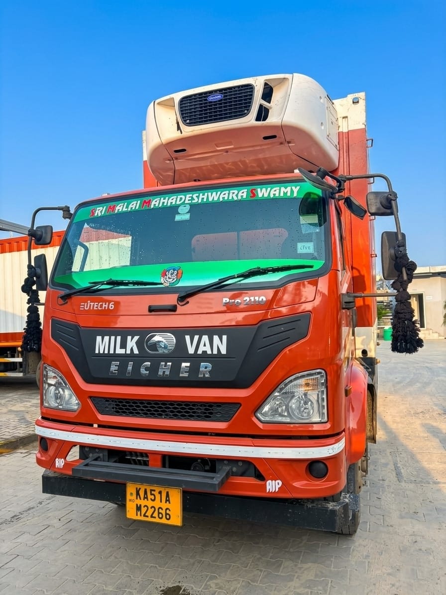 Front view of an orange Eicher milk van with a refrigeration unit